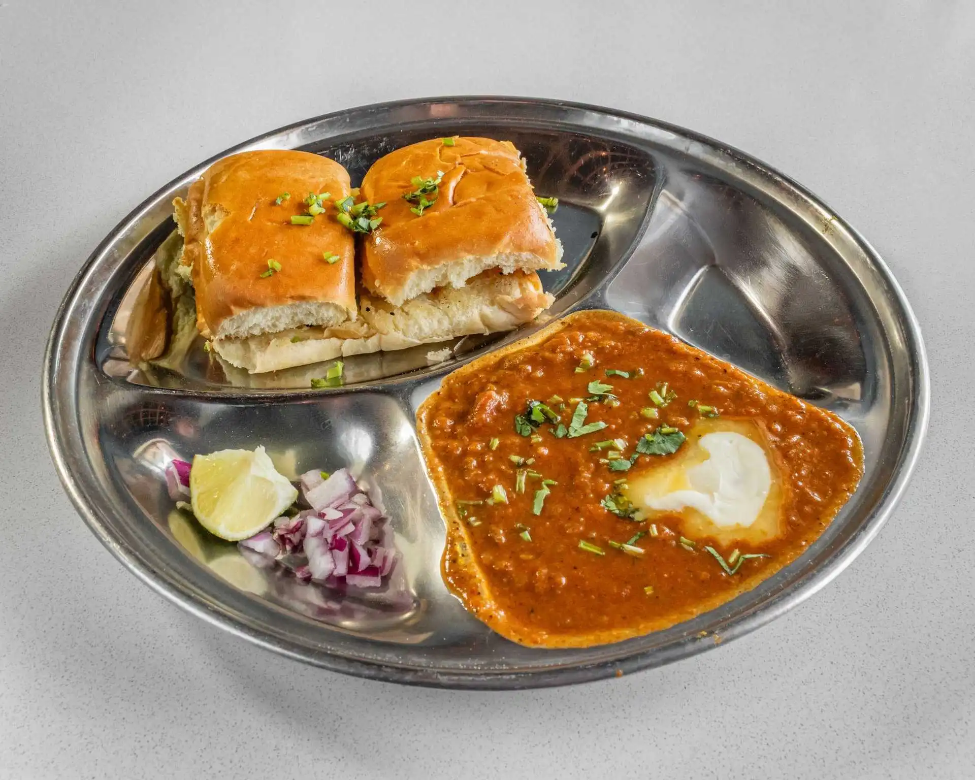 Garlic Naan freshly baked with Indian curry at Chef's Indian Kitchen Medicine Hat